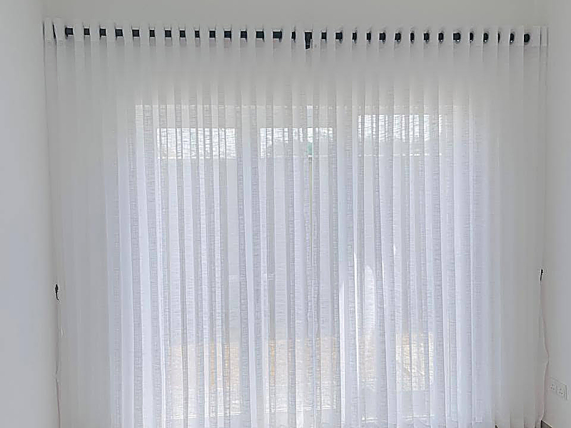 Sheer curtains installed in a bright interior